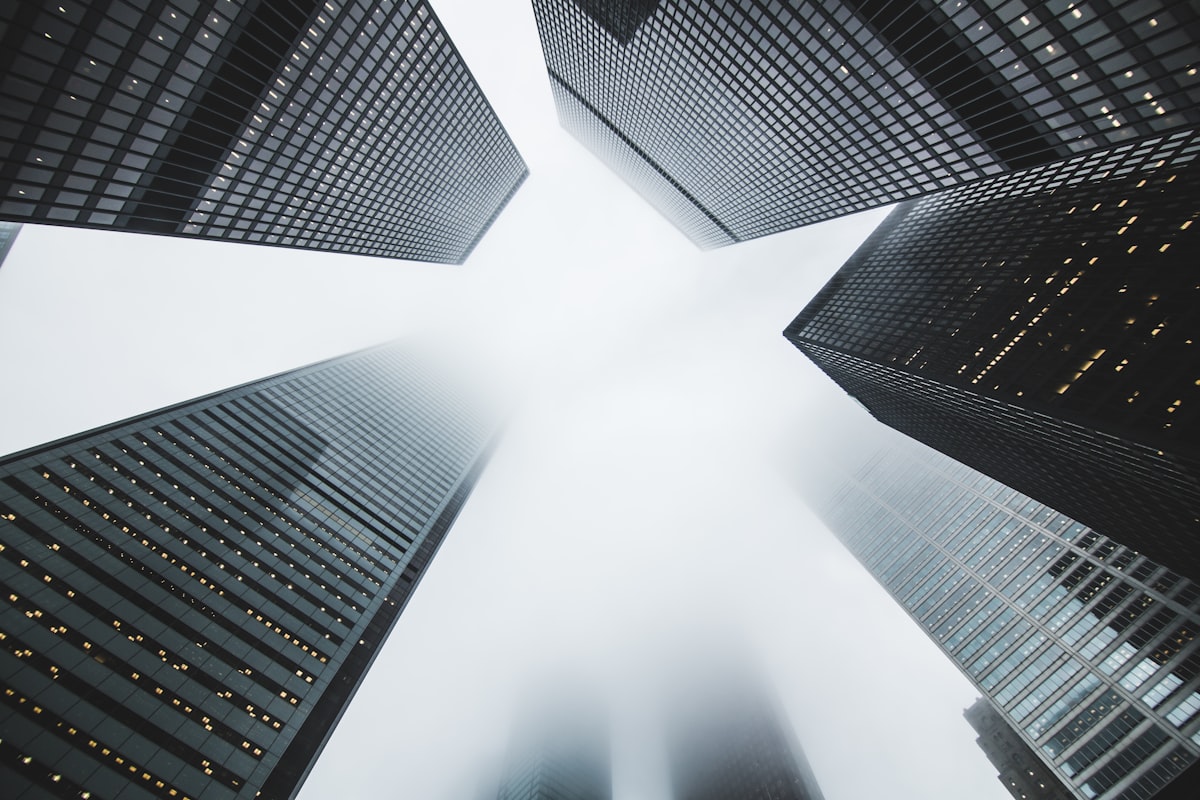 Towers dissolving into fog, photographed from street level
