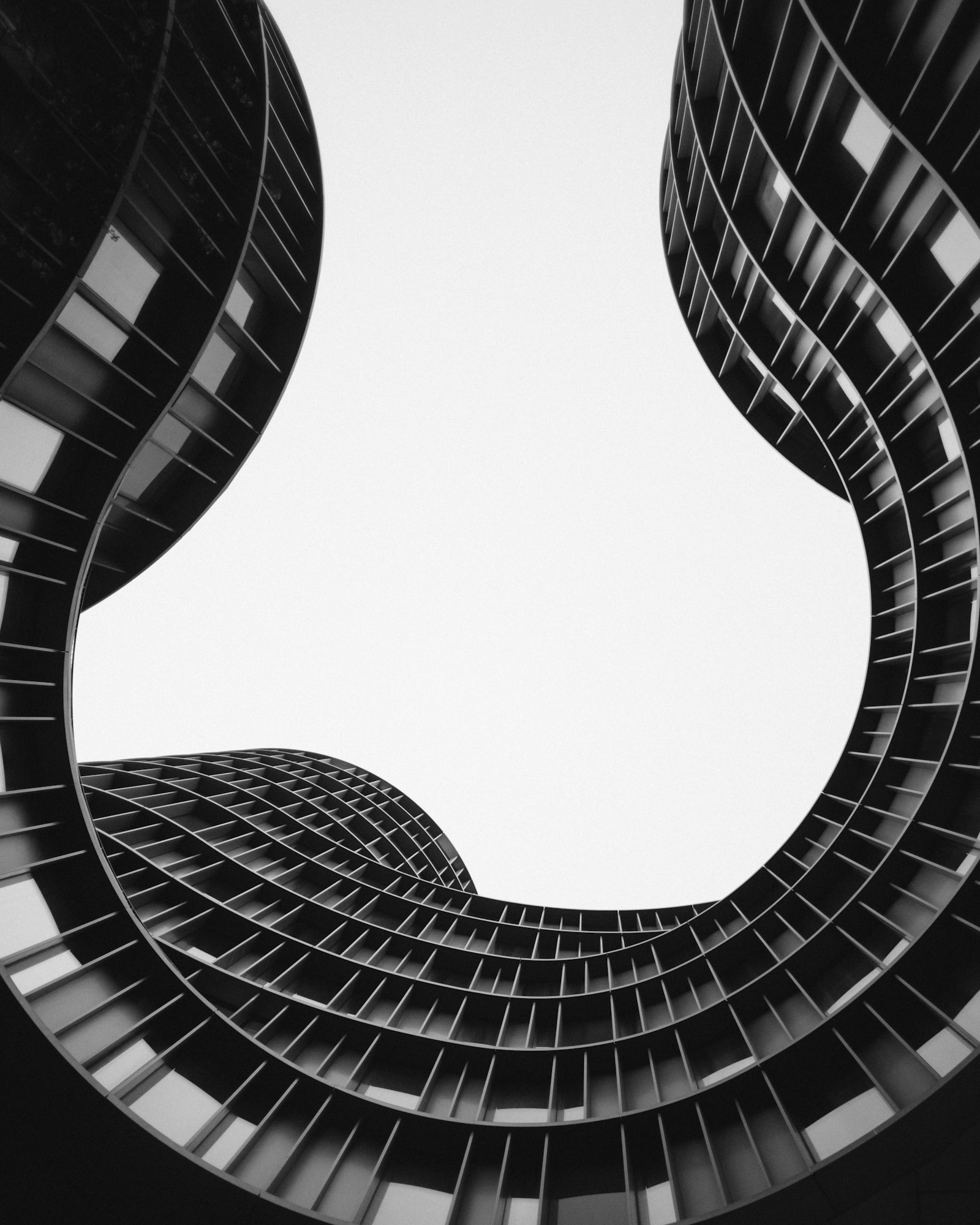 Curved balcony rings of twin towers, photographed from below